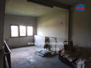 Spacious unfurnished room with large windows and natural light