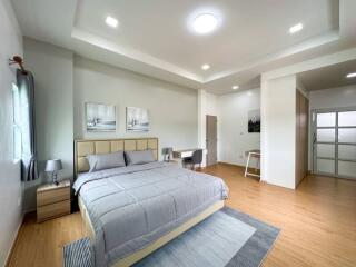 Spacious master bedroom with modern decor and plenty of natural light