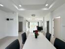 Spacious modern meeting room with white walls, long table, and bright lighting