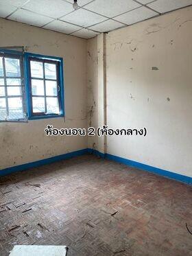 Unrenovated empty bedroom with blue window frames
