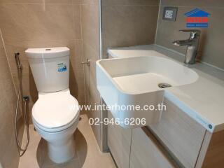 Modern bathroom in apartment with sink and toilet