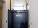 Elegant entryway with black decorative door and mirrored detail