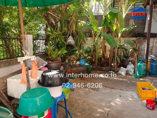 Outdoor utility space surrounded by lush greenery