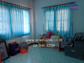 Cozy bedroom with blue curtains and ample natural light