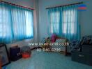 Cozy bedroom with blue curtains and ample natural light