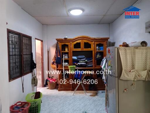 Interior of a bedroom with traditional wooden furniture and cluttered space