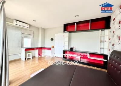 Bright and modern kitchen with red accents and ample shelving