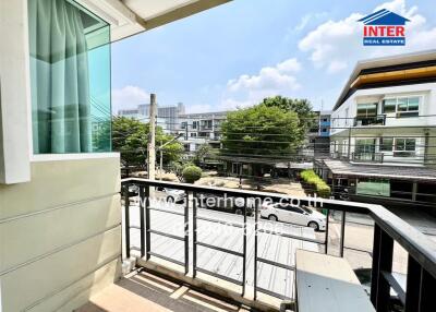 Spacious balcony overlooking the street with ample sunlight