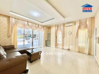 Spacious and brightly lit living room with modern furniture and elegant curtains