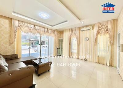 Spacious and brightly lit living room with modern furniture and elegant curtains
