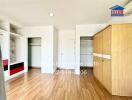 Spacious bedroom with wooden flooring and built-in storage