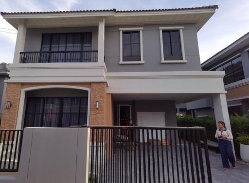 Modern two-story house with front porch and balcony