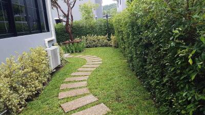Well-maintained garden pathway beside a house