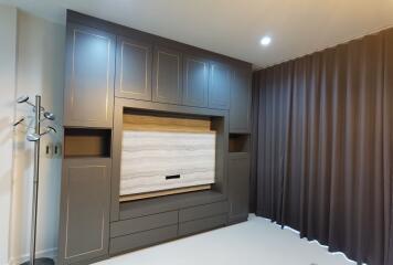 Modern bedroom with built-in wall unit and warm lighting