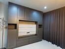 Modern bedroom with built-in wall unit and warm lighting