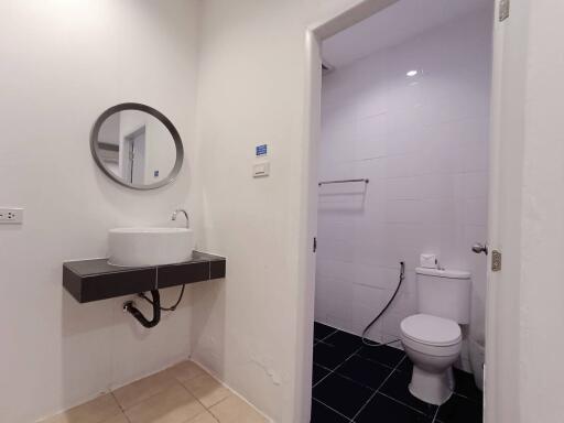 Modern bathroom with elegant sink and well-lit toilet area