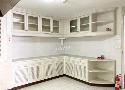 Spacious empty kitchen with white cabinetry and ample storage