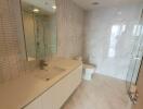 Modern bathroom with glass shower and beige tiles