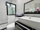 Modern bathroom with large mirror and white sink