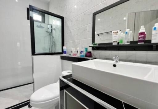 Modern bathroom with large mirror and white sink