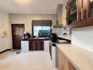 Spacious modern kitchen with marble countertops and wooden cabinets