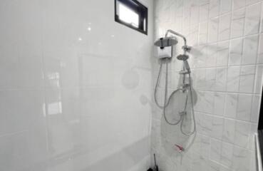 Modern bathroom interior with white tiles and shower installation