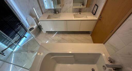 Modern bathroom with double sink and bathtub