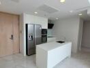 Modern kitchen with built-in appliances and ample lighting