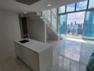 Modern high-rise apartment interior with lustrous tiled flooring, expansive windows offering city skyline views, and a sleek staircase