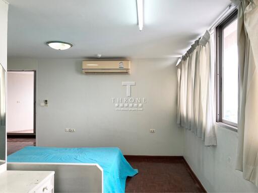 Bright and spacious empty bedroom with large windows and air conditioning