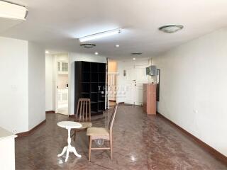 Spacious living room with open layout leading to kitchen