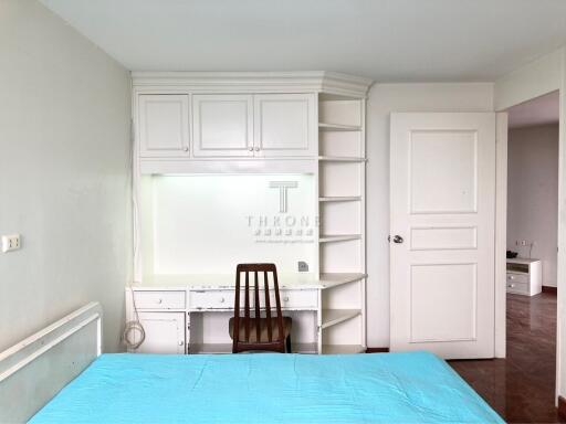 Spacious bedroom with built-in cabinets and desk area