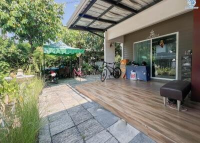 Spacious outdoor patio with tile flooring and a variety of amenities