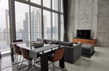 Spacious living room with large windows and city view