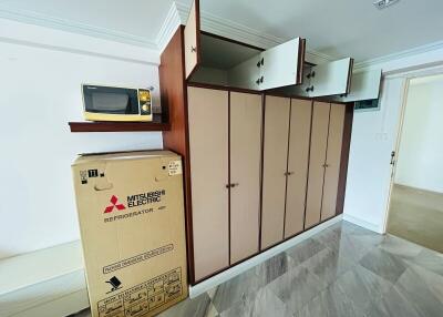 Compact kitchen storage area with microwave and refrigerator box