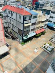 Aerial view of a modern multi-story building surrounded by city infrastructure