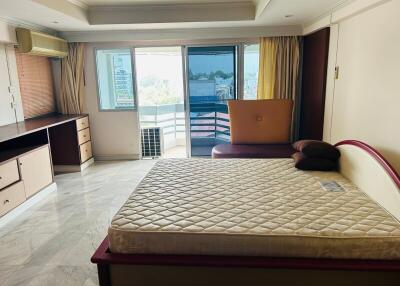 Spacious bedroom with natural light and balcony access