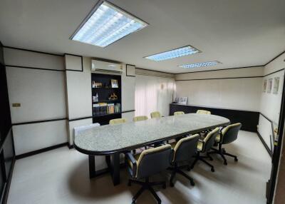 Spacious office conference room with large granite table and ergonomic chairs