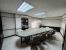 Spacious office conference room with large granite table and ergonomic chairs