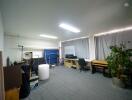 Spacious and versatile studio with modern lighting and ample storage space