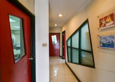Interior hallway with red doors and decorative glass windows