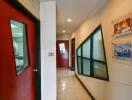 Interior hallway with red doors and decorative glass windows