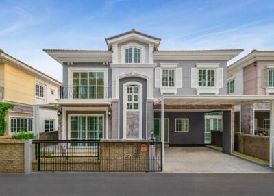 Elegant two-story residential house with secure gate and driveway