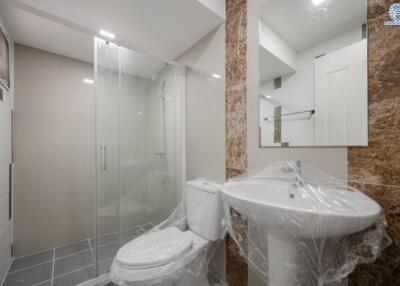 Modern bathroom interior with glass shower and new fixtures