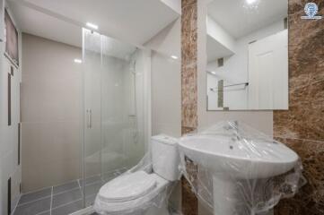 Modern bathroom interior with glass shower and new fixtures