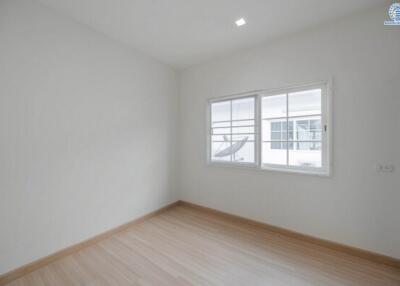 Spacious and well-lit empty bedroom with large window