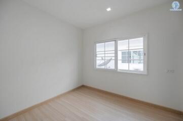 Spacious and well-lit empty bedroom with large window