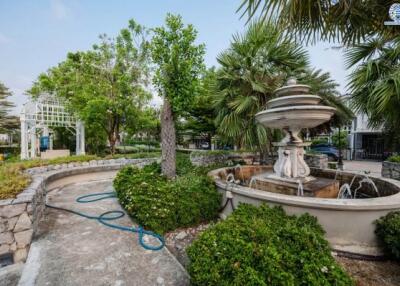 Elegant garden with a decorative fountain and lush greenery