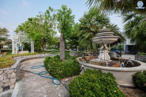 Elegant garden with a decorative fountain and lush greenery