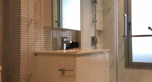 Modern bathroom with beige tiles and sleek fixtures